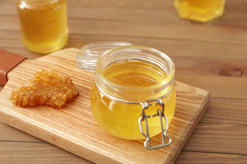 Jar of sweet honey on table