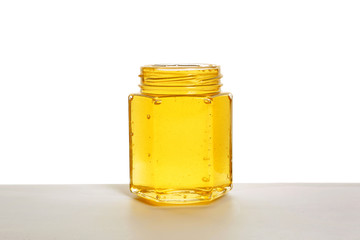 Jar of sweet honey on white background