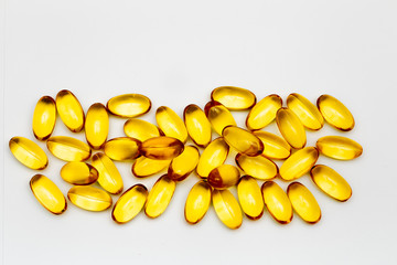 Close up of food supplement oil filled capsules suitable for: omega 3, omega 6, vitamin A, vitamin...