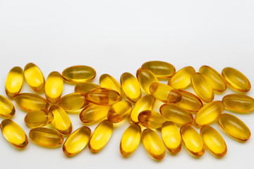 Close up of food supplement oil filled capsules suitable for: omega 3, omega 6, vitamin A, vitamin D, vitamin E