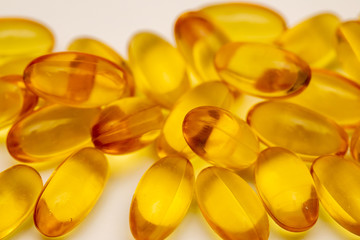 Close up of food supplement oil filled capsules suitable for: omega 3, omega 6, vitamin A, vitamin...