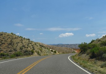 Paved road winding through picturesque landscape in Wyoming.