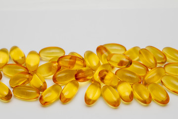 Close up of food supplement oil filled capsules suitable for: omega 3, omega 6, vitamin A, vitamin D, vitamin E