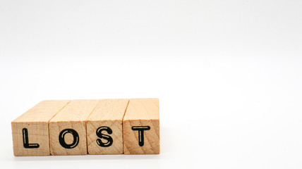 Wooden Text Block of "LOST" on Isolated Background