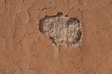 Detail of a cracked clay wall