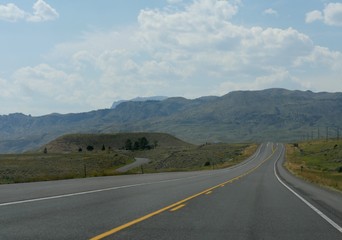 Paved roads and landscape on a drive-around in Wyoming, wide shot.