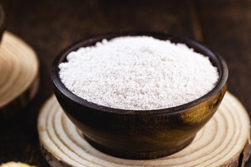 wooden bowl with tapioca. Also called Goma, it is the starch extracted from cassava, usually...