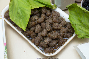 Ripe mulberries in bowl on table