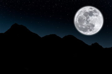 Fototapeta na wymiar Full moon over silhouette mountain in the dark night.