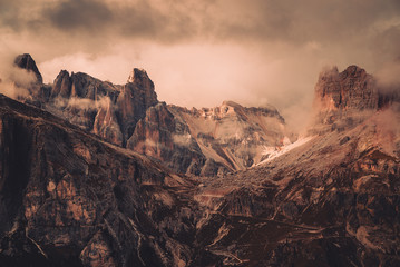 Late afternoon sunlight shining on The Dolomites mountain landscape near the alpine town of...
