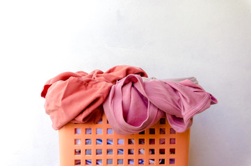 Clothes that have already been worn and placed in a basket are waiting to be washed, with the main scene being white.