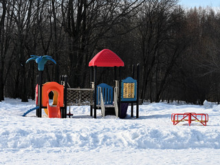 snowy playground in a city park