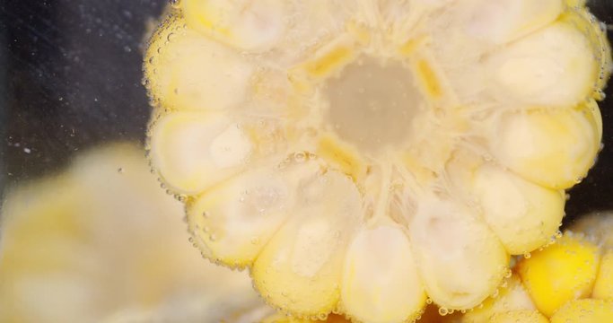 Round cut corn under water with air bubbles.