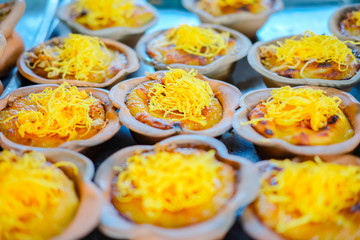 Thailand cup dessert with golden threads (Foi tong) in terracotta cup.