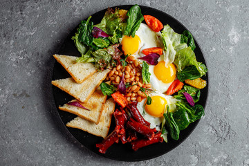 Great breakfast with fried eggs, toast, lettuce and tomato. Photographed in the vicinity