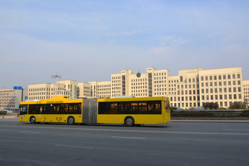 Fototapeta na wymiar MINSK, BELARUS - MARCH 29 2020 :The House of the Government of the Republic of Belarus and yellow bus