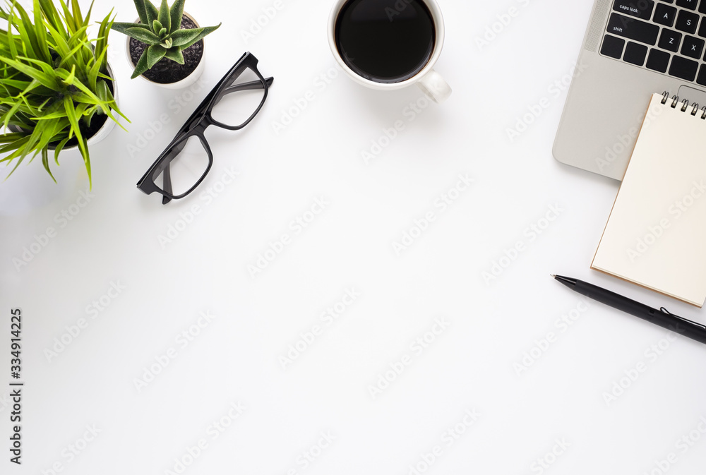 Poster workplace in office with white desk. top view from above of laptop with notepad and coffee. space fo
