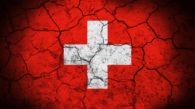 Switzerland flag on the cracked background texture. 