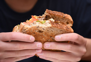 close-up eating toasted steak sandwich