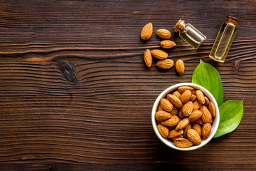 Spa and aromatherapy. Almond oil in small bottles on wooden background top-down copy space