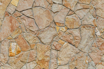 Textures. The wall is lined with natural sandstone. The facade of the house is lined with natural stone. Texture of natural stone on the wall