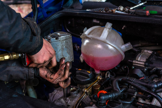 The Master Repairs The Engine In The Car Service During A Malfunction