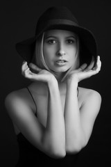 Black and white portrait blondes on black background in a hat and Tank Top With Thin Straps