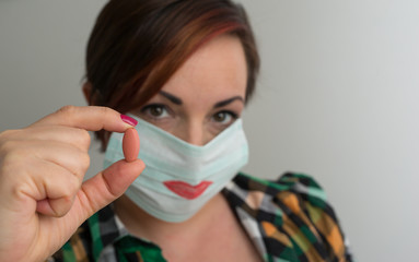 Coronavirus pandemic curfew tips against boredom: woman wearing lipstick surgical mask.