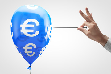 Concept: European currency vulnerability. Balloon with euro symbol and needle in hand.