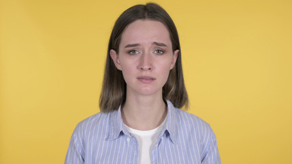 Crying Sad Young Woman Isolated on Yellow Background