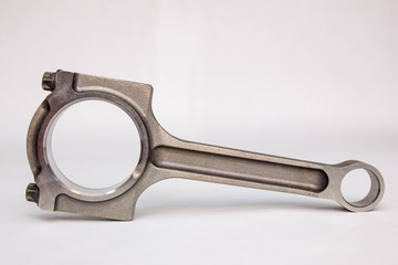 Connecting rod from a car engine isolated on white.