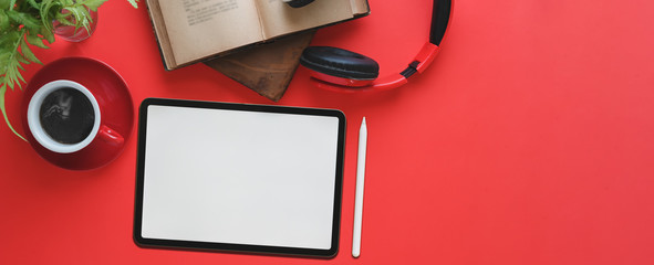 Top view image of computer tablet with white blank screen and stylus pen putting on red working...