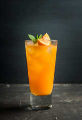 Fresh cocktail with vodka and orange juice on the rustic background. Selective focus. Shallow depth of field.