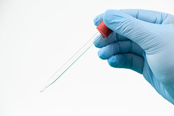Blank pipette on hand of doctor wear blue glove