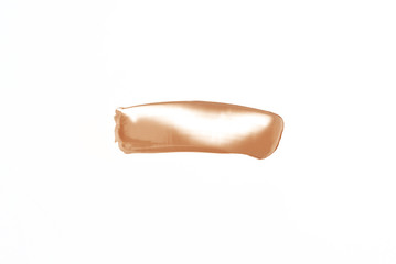 Smear of light foundation on an isolated white background.