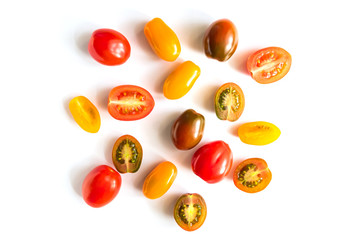 various colorful tomatoes isolated on white background. Top view, flat lay. Creative layout