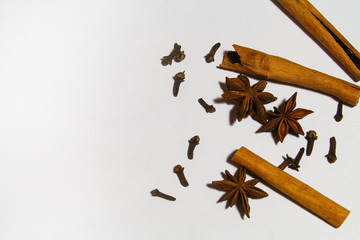 Spices cinnamon and cloves on a white background. place for text.