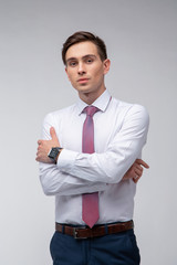 Young, handsome man in a white shirt with a tie on a white background in studio