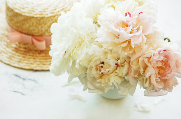 Straw hat and peonies