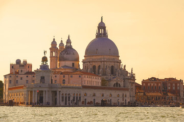Fototapeta na wymiar Basilica di Santa Maria della Salute and the ancient customs building of Punta della Dogana on a sunny September evening. Venice, Italy