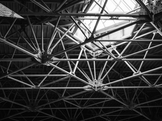 ceiling with metal structures in a modern building - geometry in architecture. Black and white photo