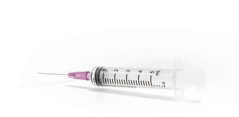 Disposable syringe and hypodermic needle on white background