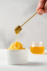 National food cuisine of the Middle East. A male hand pours honey for a chak-chak dessert using a honey dipper. Vertical orientation, copy space.