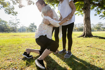 Female elderly was trying to stand up,asian daughter help,care,support her senior mother to stand...