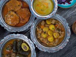 Eid Mubarak Traditional Ramadan Iftar dinner. Assorted tasty food in authentic rustic dishes on wooden table background.