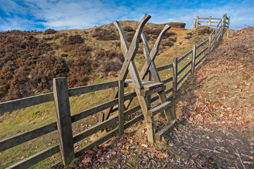 Wooden fence stile in rural countryside landscape