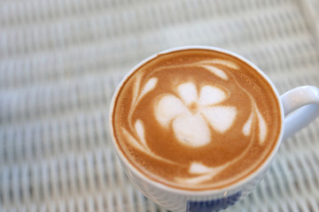 frangipani plumeria fragrant flower of latte art in hot coffee drink put on table in cafe restaurant