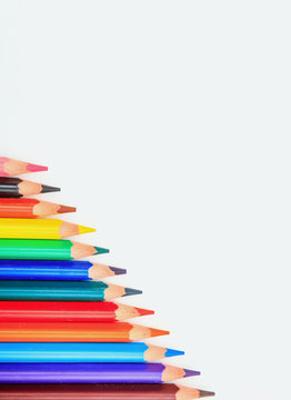 Colorful pencils on white background, top view