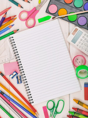 School supplies on wooden desk. Kid creativity flat lay