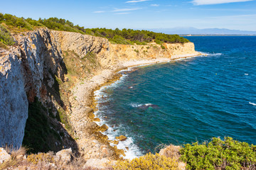 Fototapeta na wymiar View of the cliffs of the Montgri Natural Park with the Bahía de Rosas in the background. Costa Brava, Catalonia, Spain